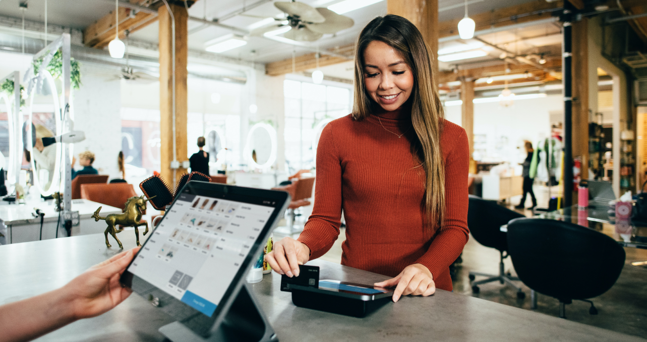 Woman checking out at retail counter