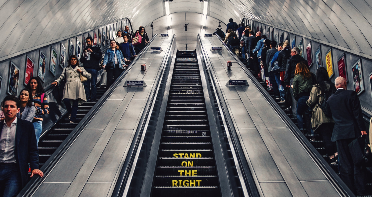 queue of people on an escalator