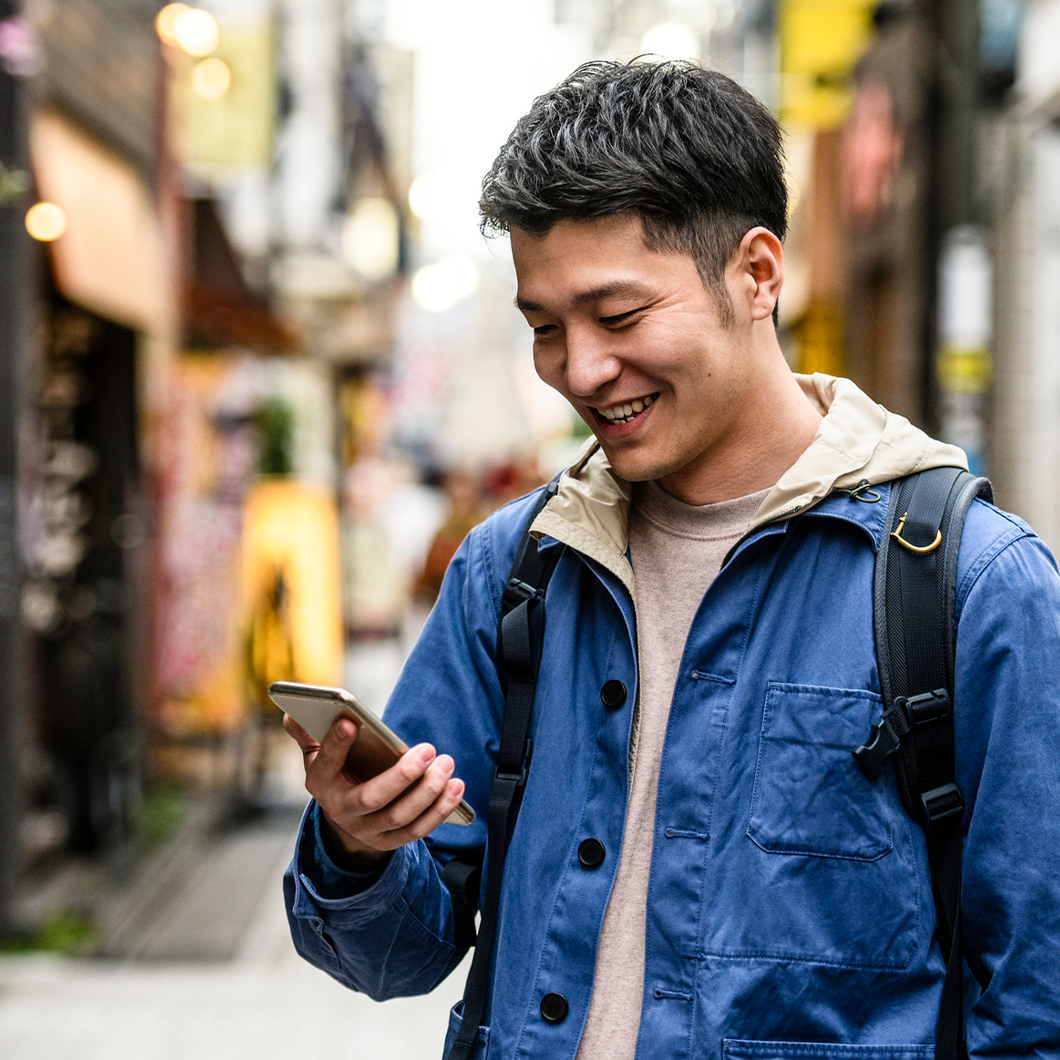male on street using a smart phone