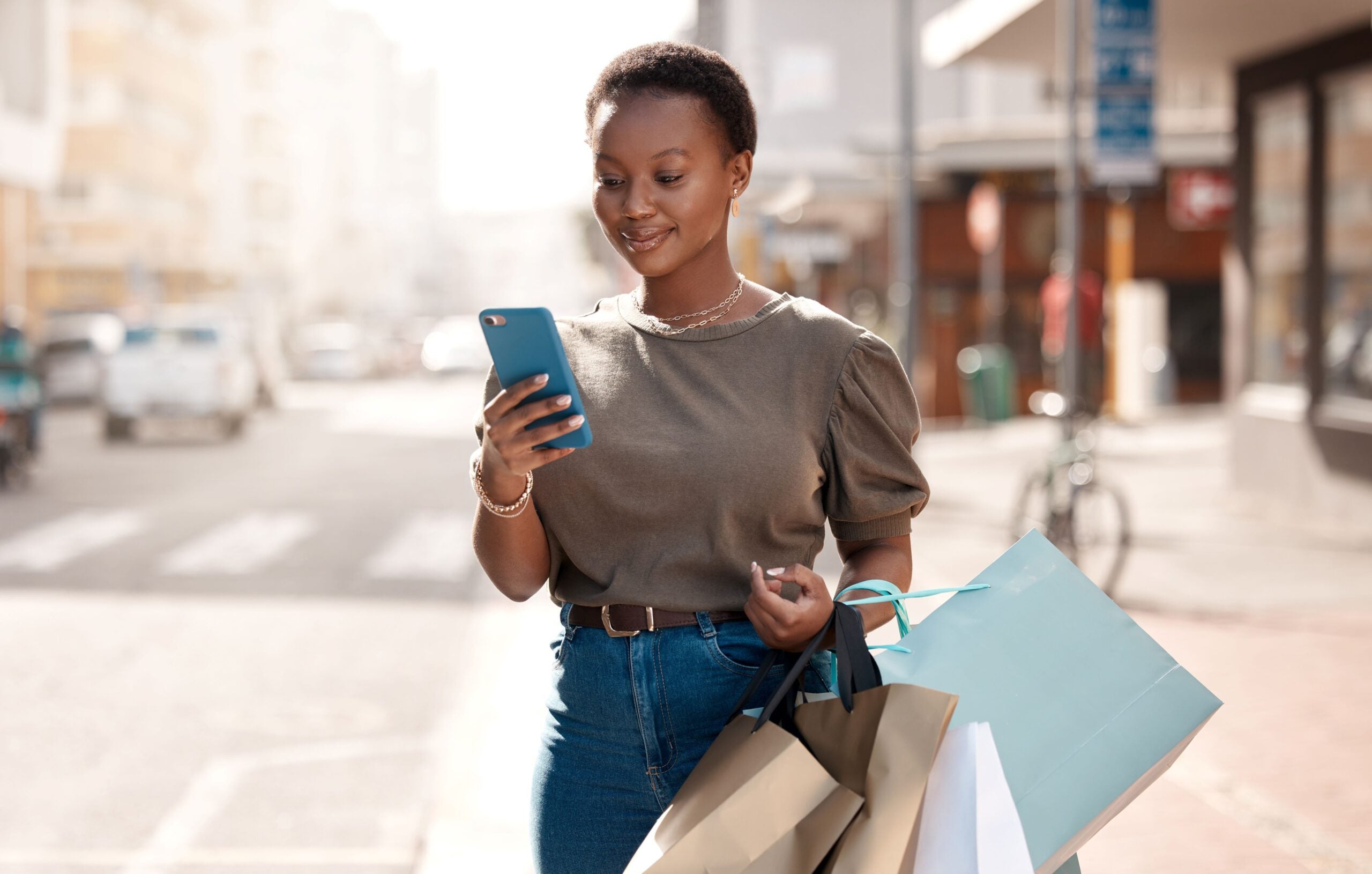 Woman with shopping bags on phone