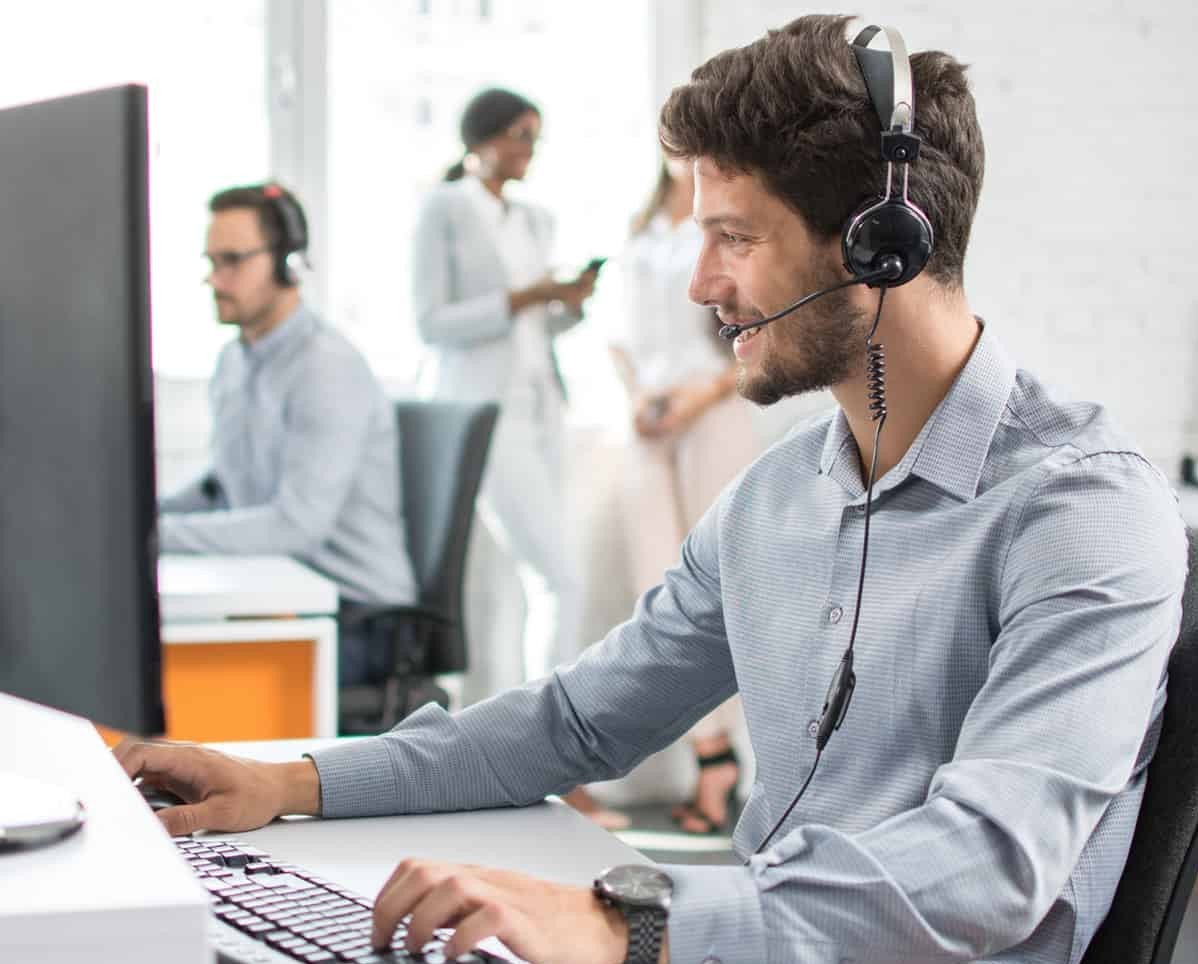 Male contact center agent in light blue shirt