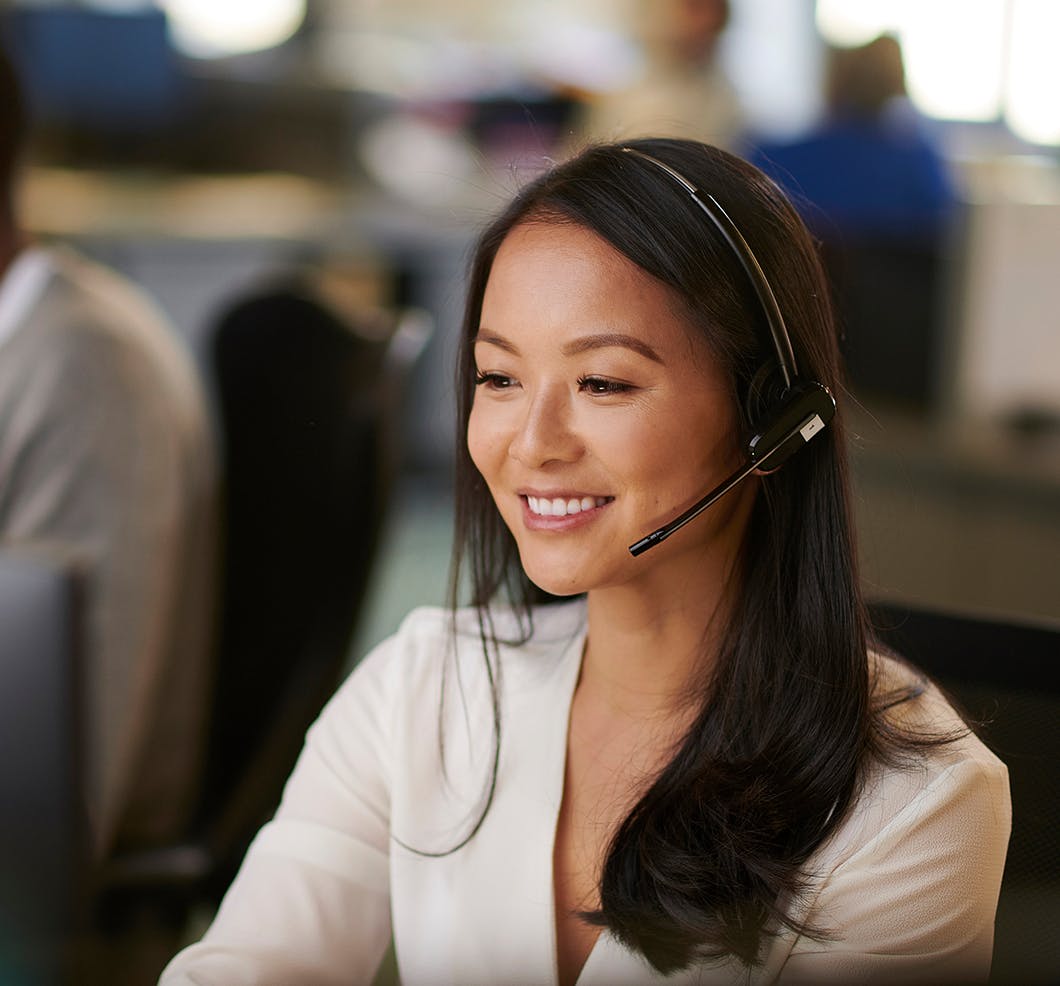Young female contact center agent with headset