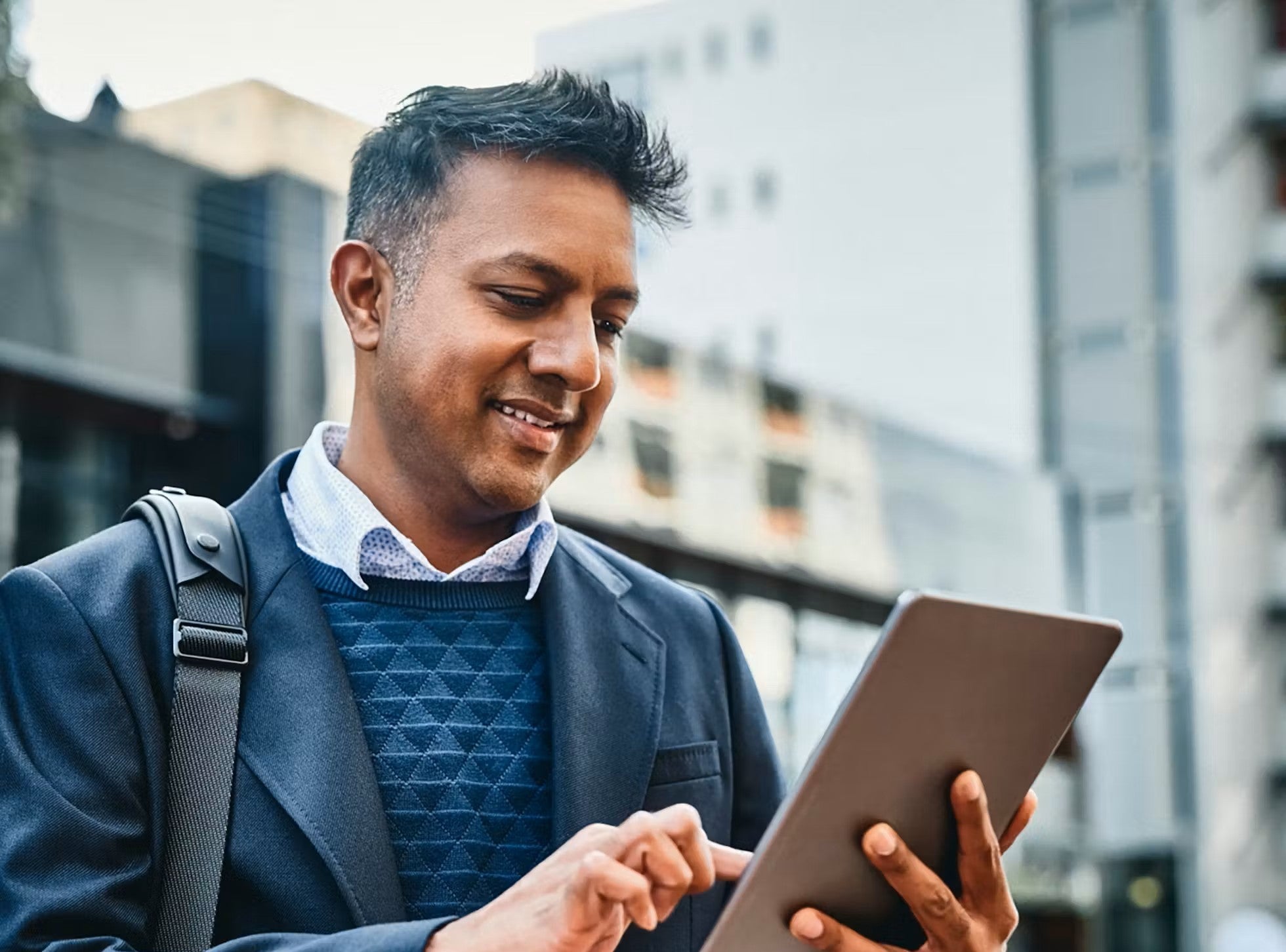 Man-using-tablet-outside-standing revised