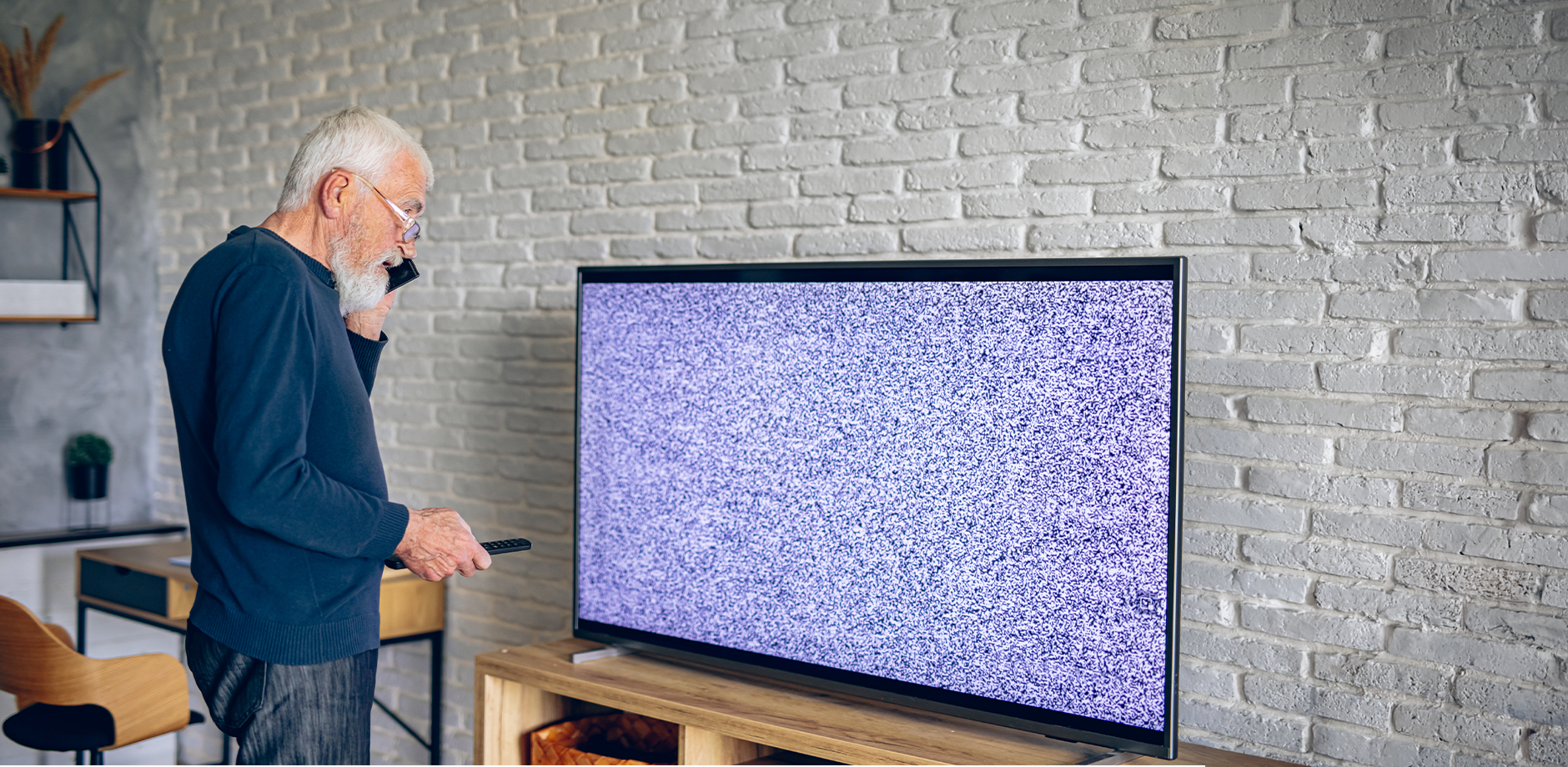 man frustrated at TV not working
