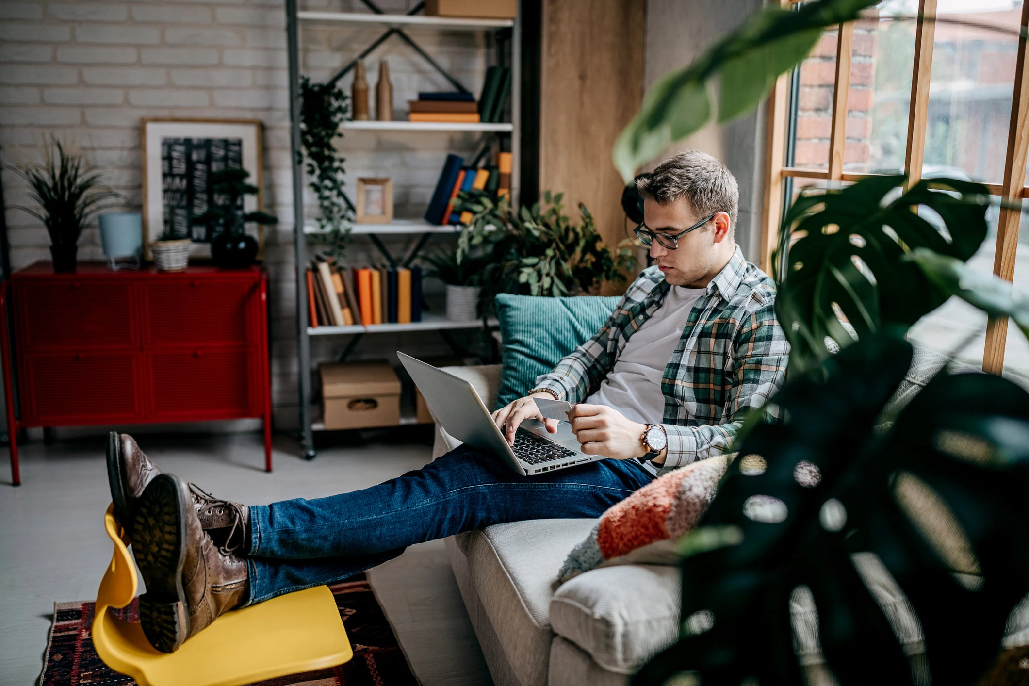 Conversational AI Improves CX - Man at home shops using laptop.