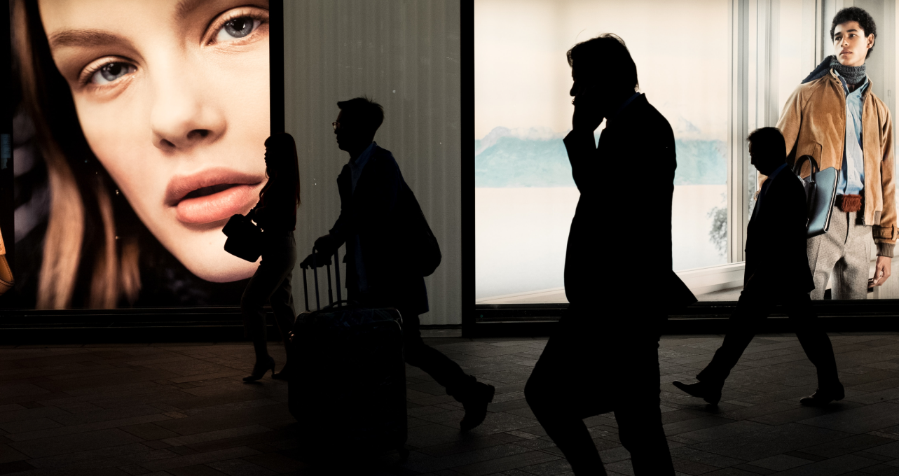 Silhouette of business man walking while talking on the phone