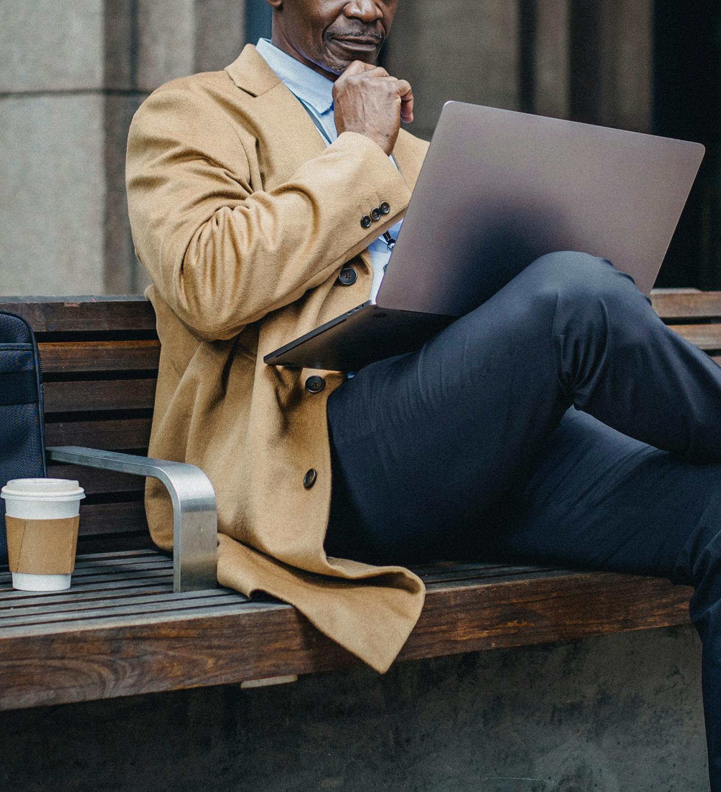 Man sitting at a bench on computer