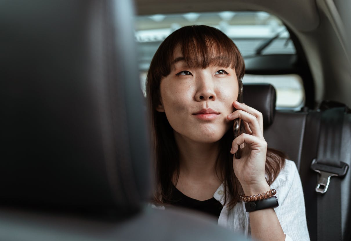 woman in car talking on the phone