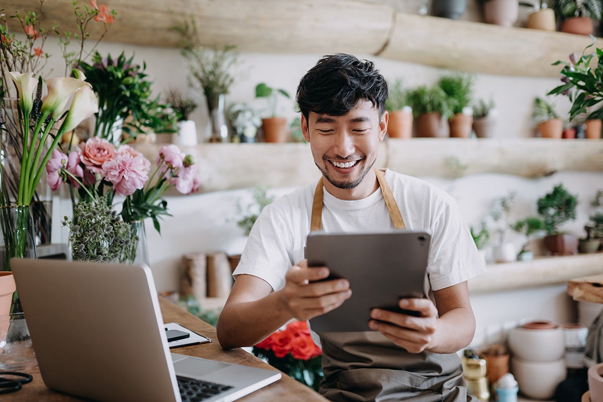 Man florist using a tablet