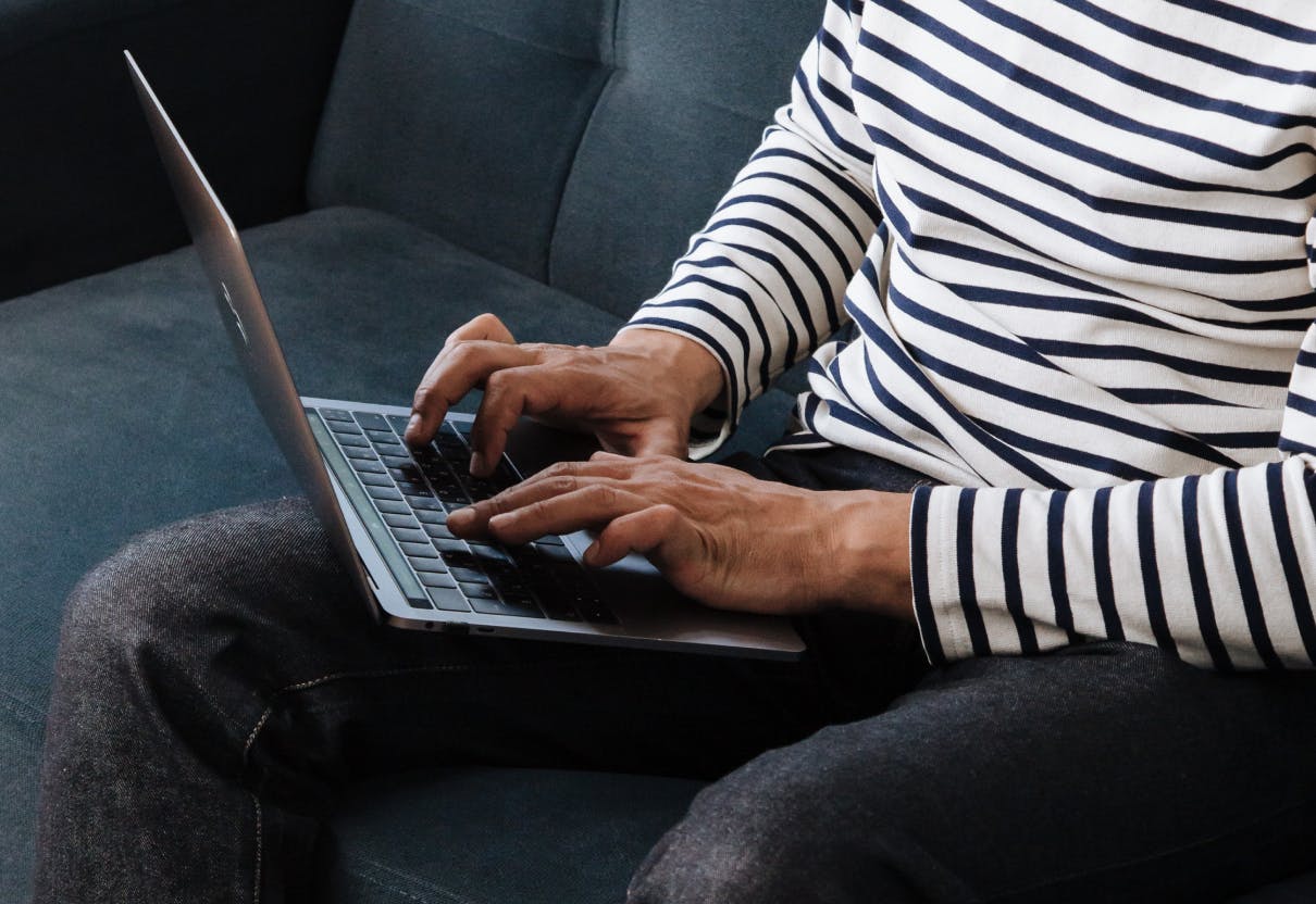 Man sitting on computer typing