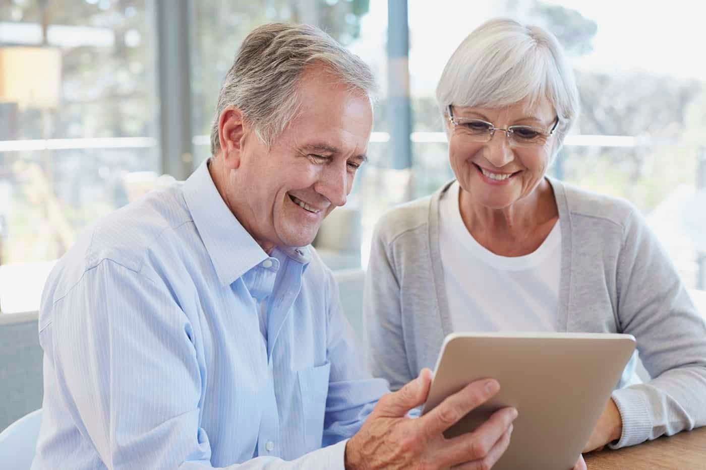 Retired couple looking at iPad