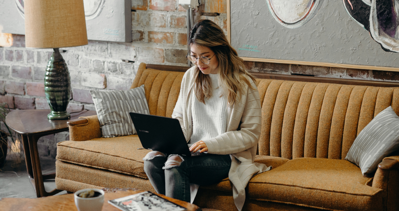 Young woman booking online from her computer.