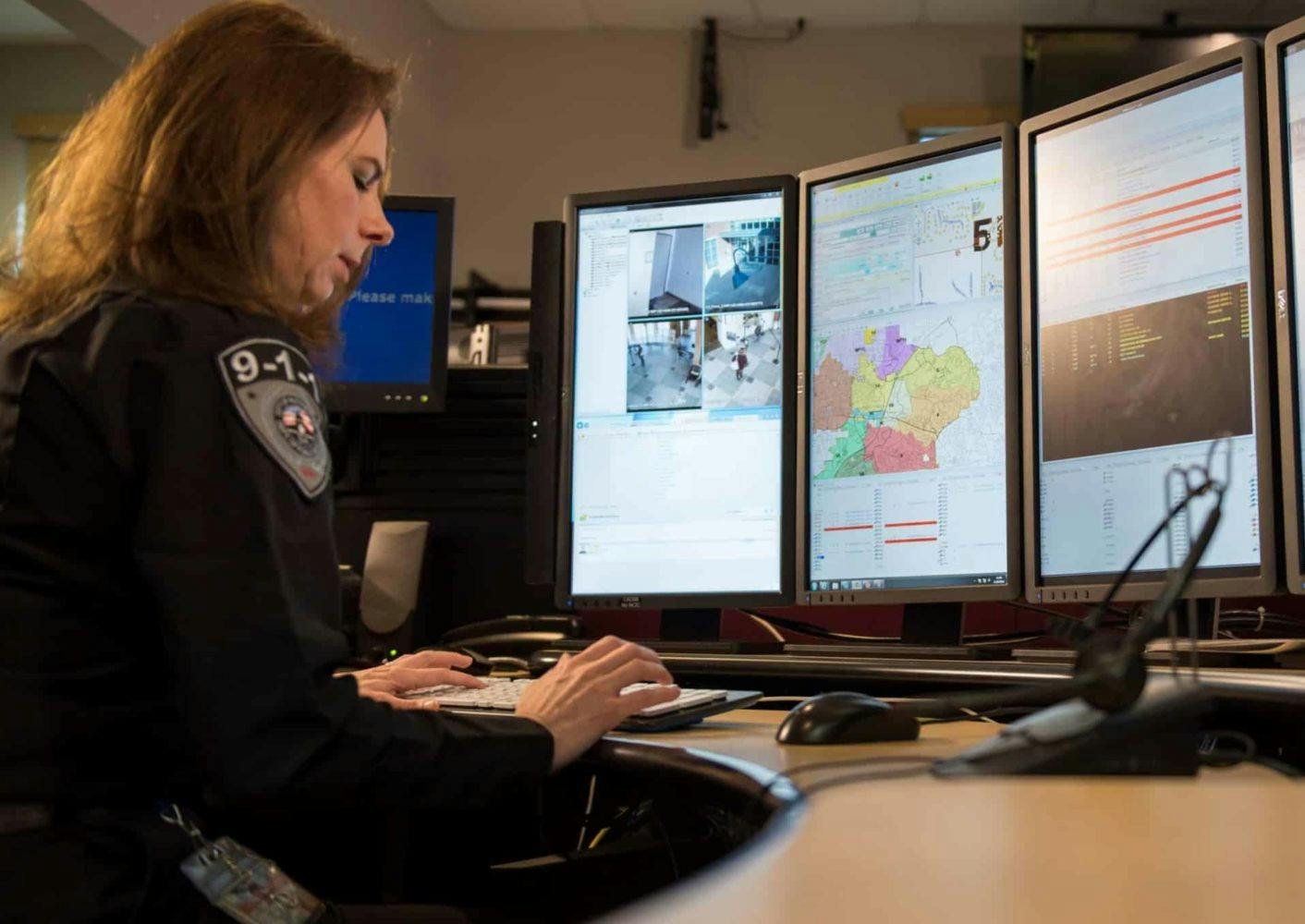 Woman cop using Verint technology for data