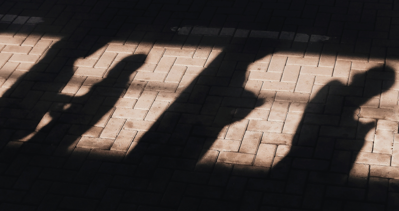 Shadows cast by a queue of people