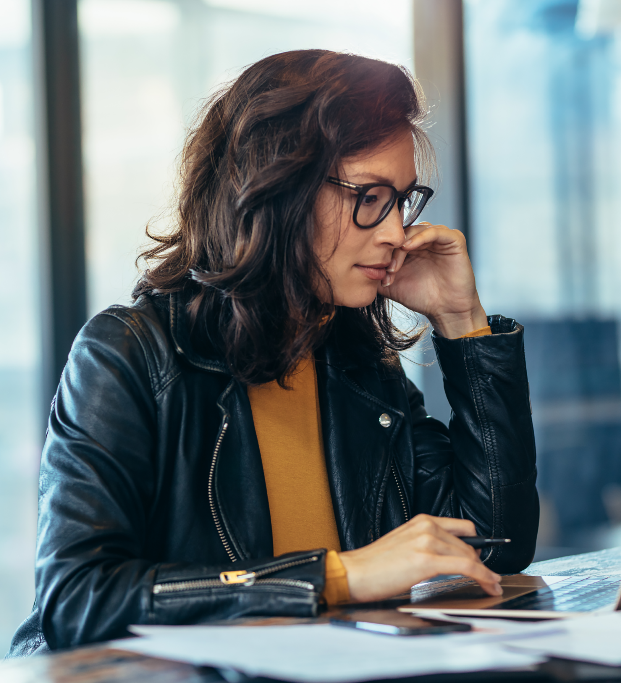 Woman sitting at table using laptop