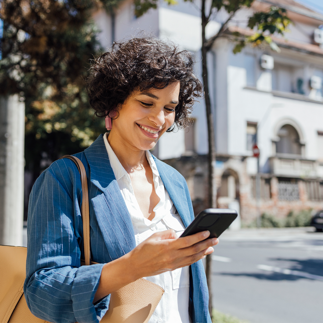woman walking outside looking at phone
