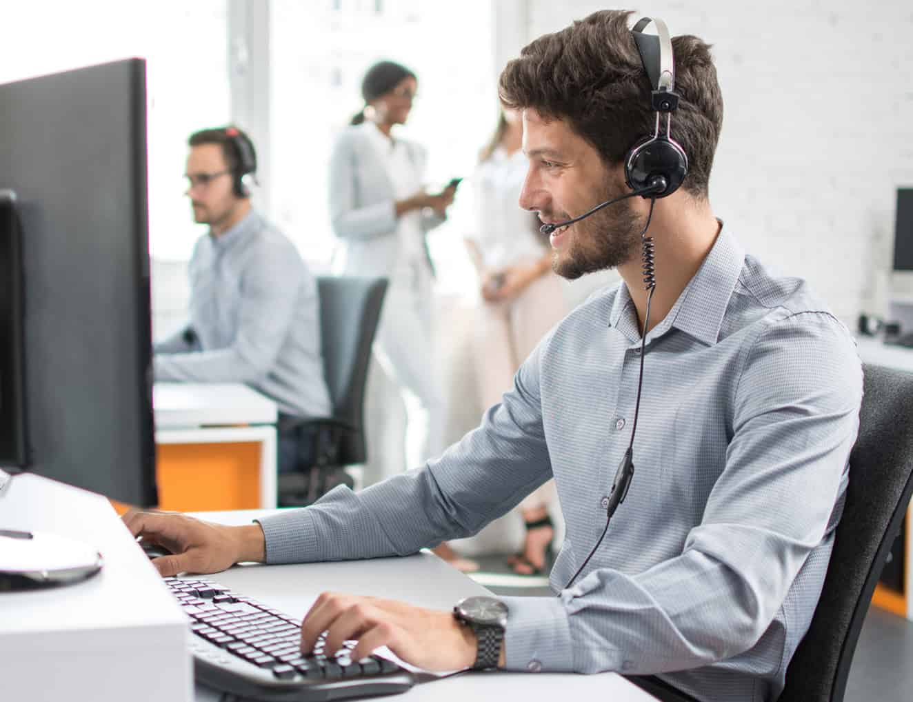 Business man working in a contact center on the phone.