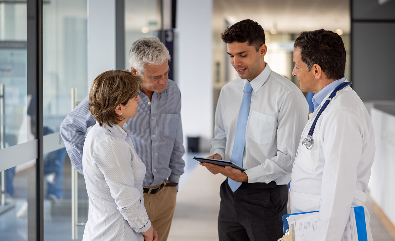 doctors and patients looking at tablet while talking