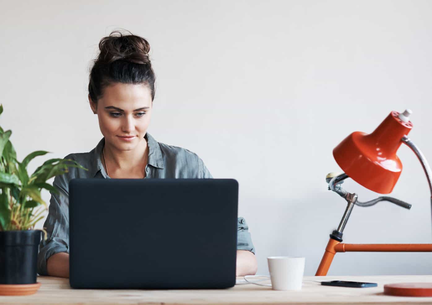 Woman sitting at a desk working on her computer