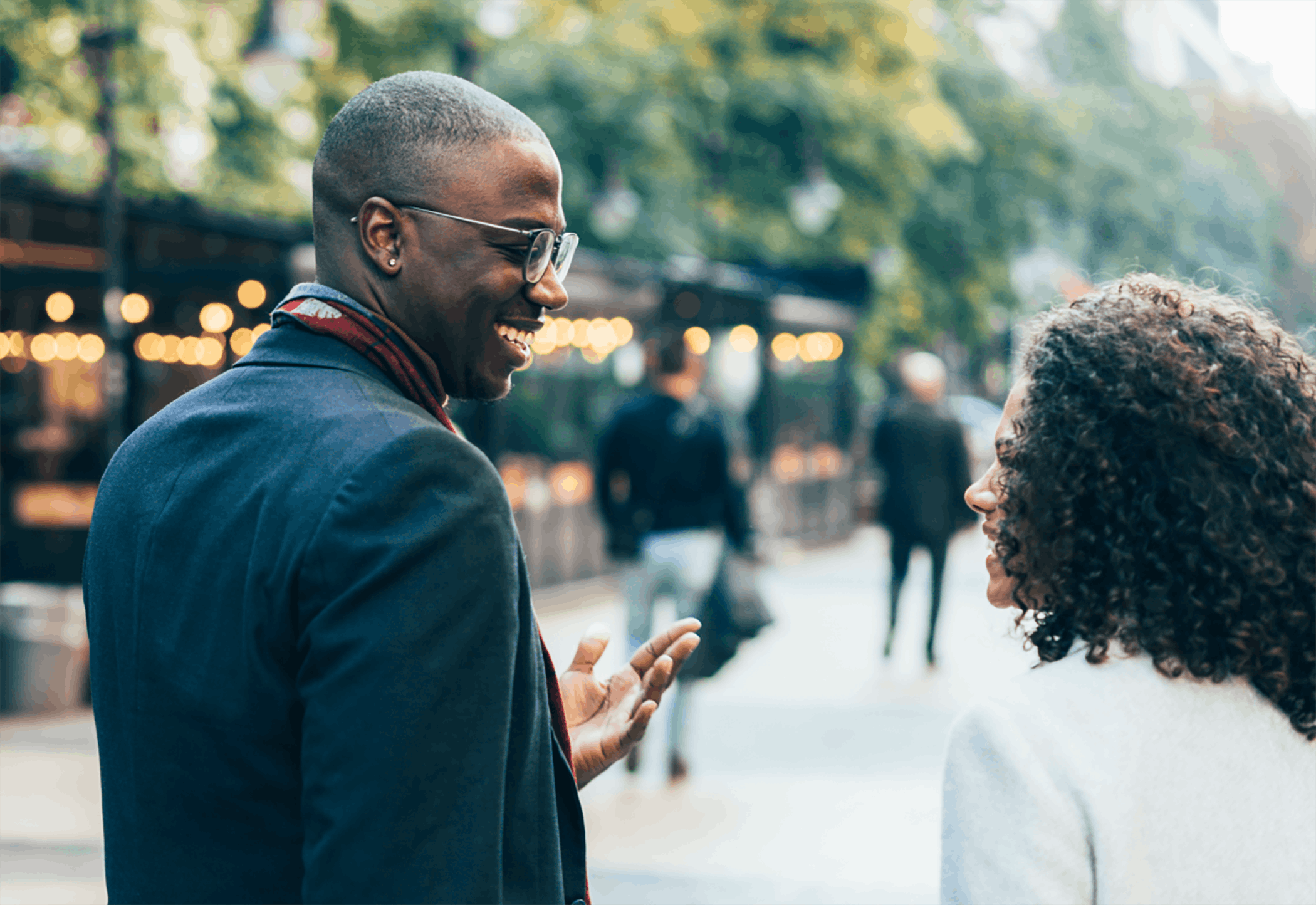 Man and woman walking outside talking