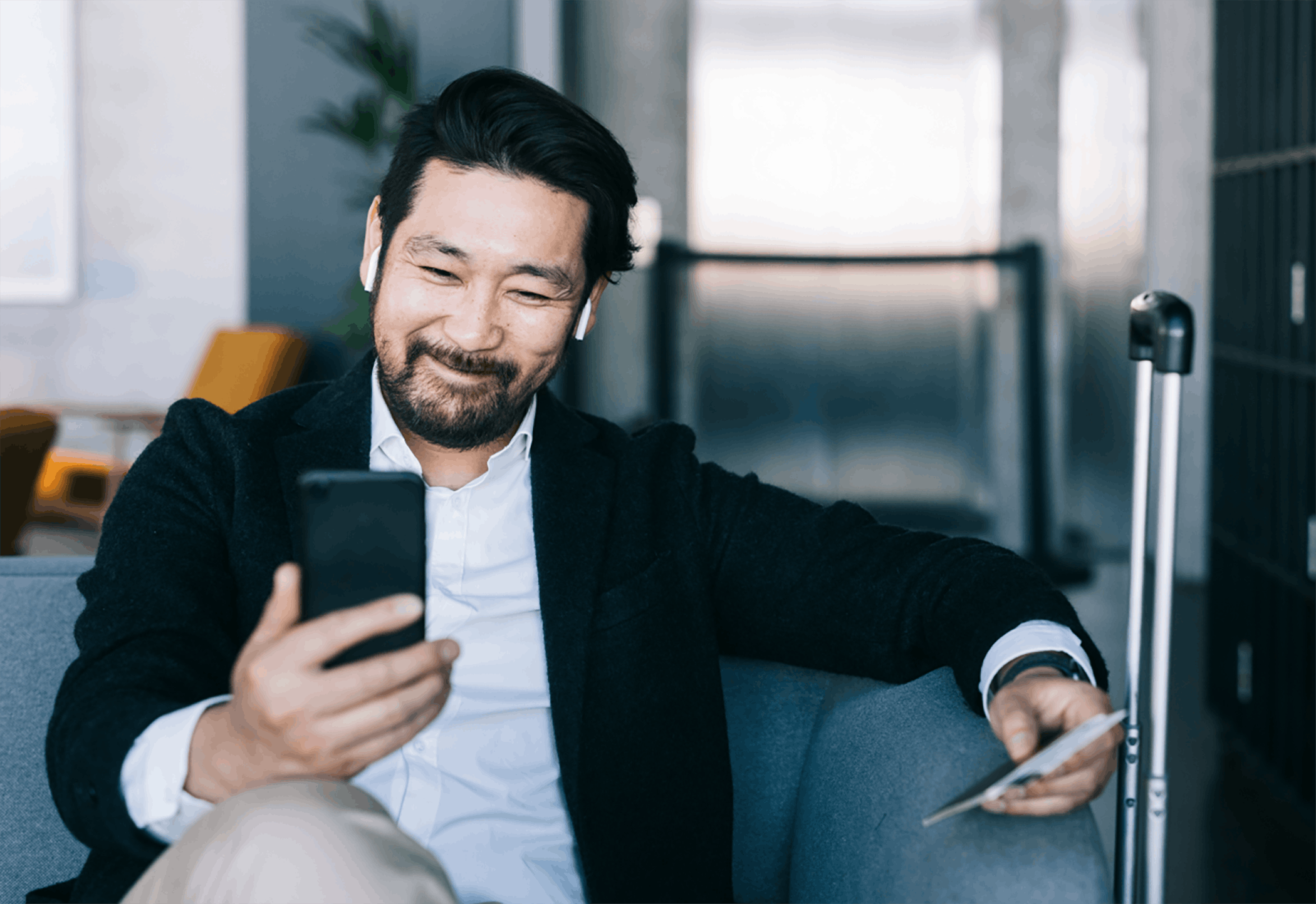 man sitting looking at phone