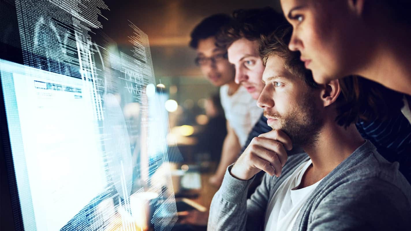 Group of people looking at a computer