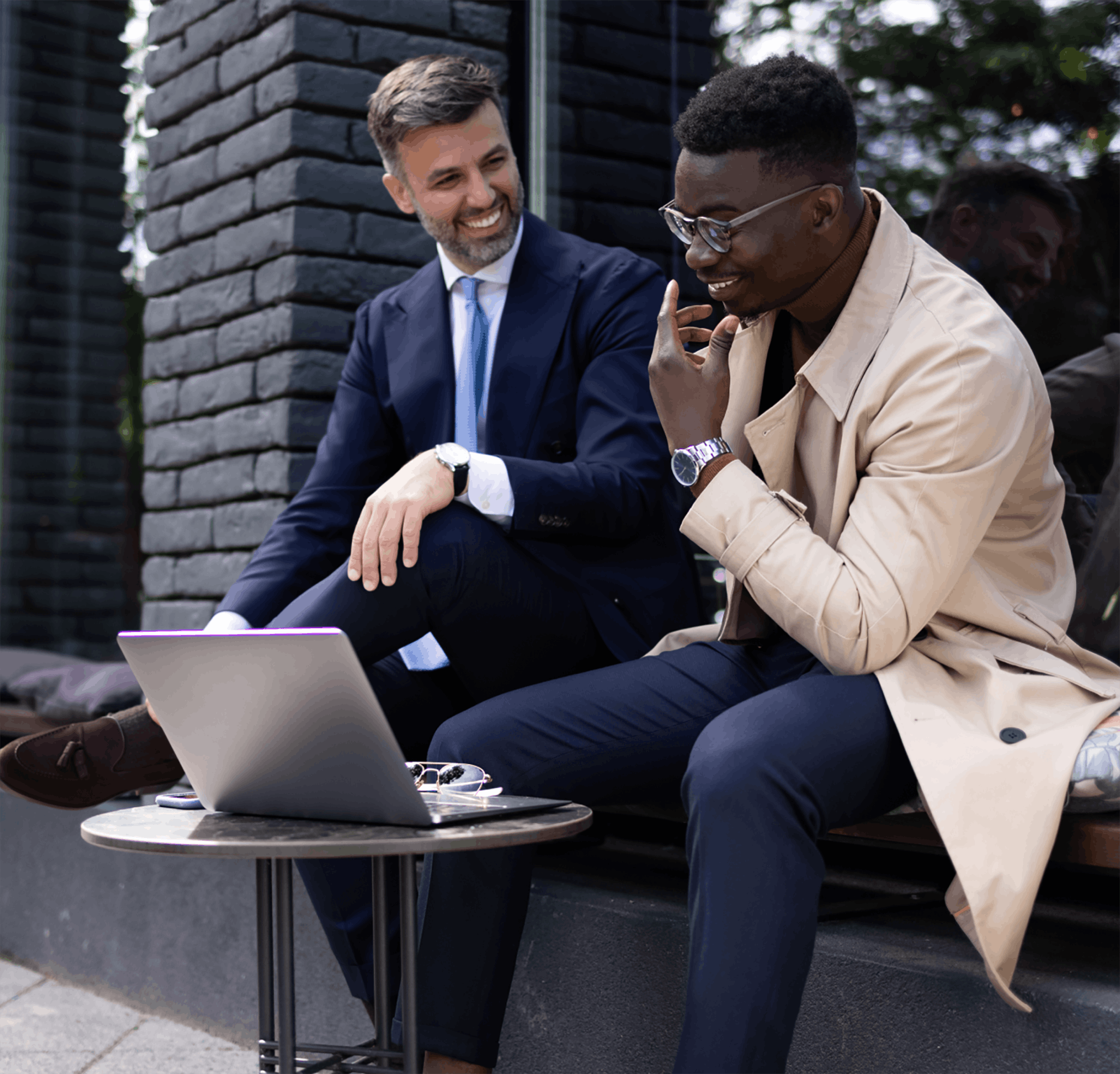 Men meeting outside with laptop