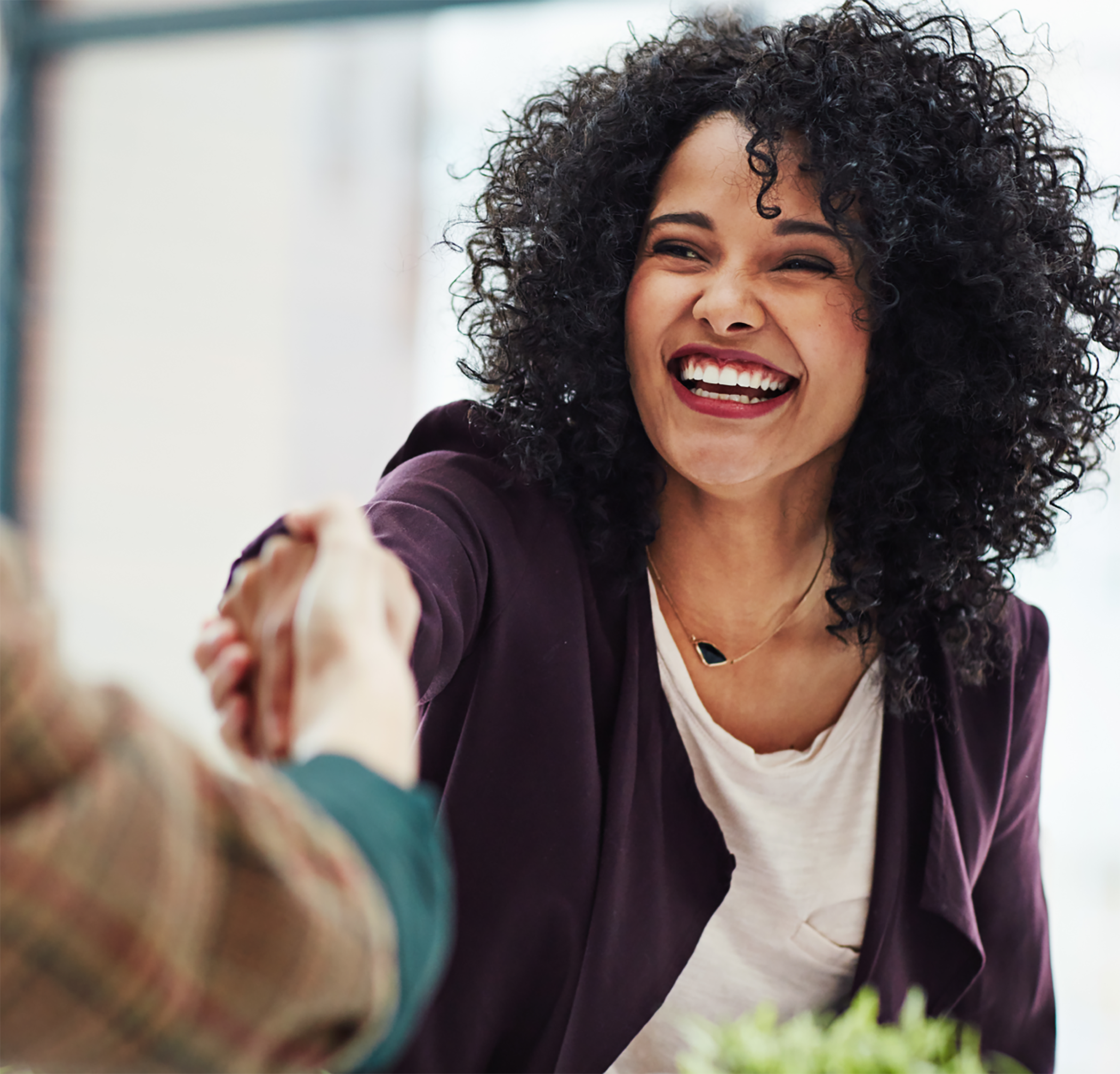 Woman shaking hand with other woman