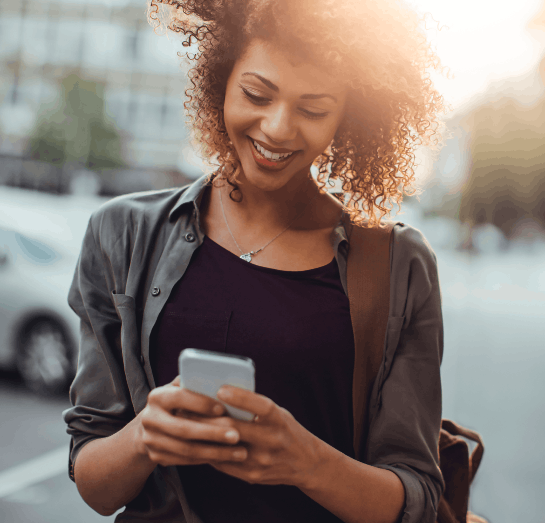 Woman walking and texting outside