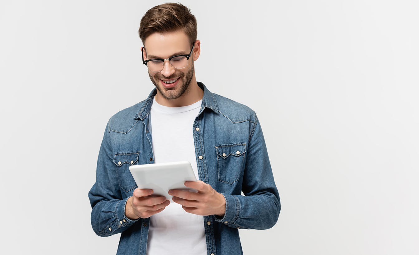 Smiling man holding an ipad