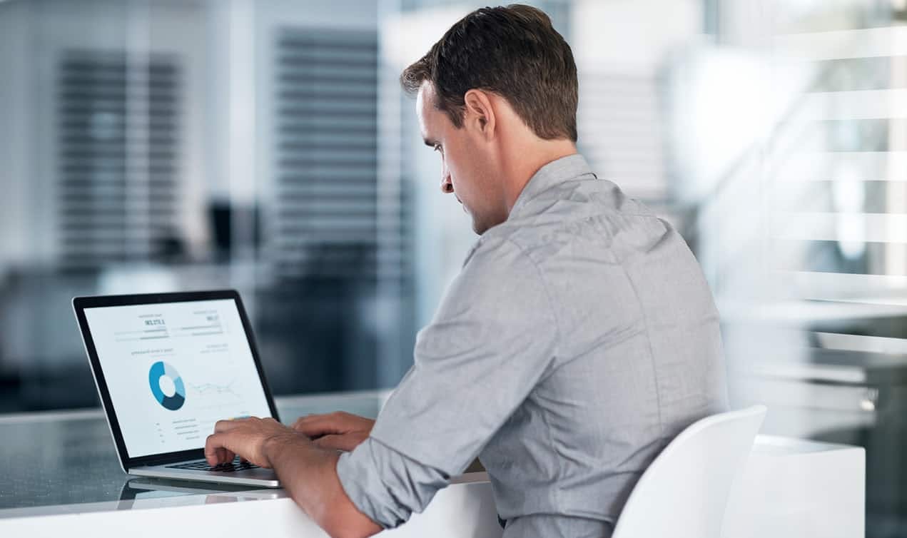 Man on computer looking at statistics