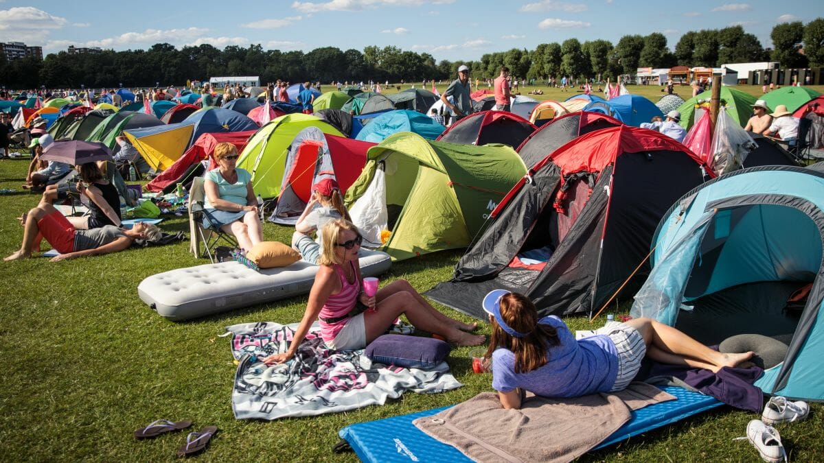 Wimbleton fans lined up, relaxing by tents