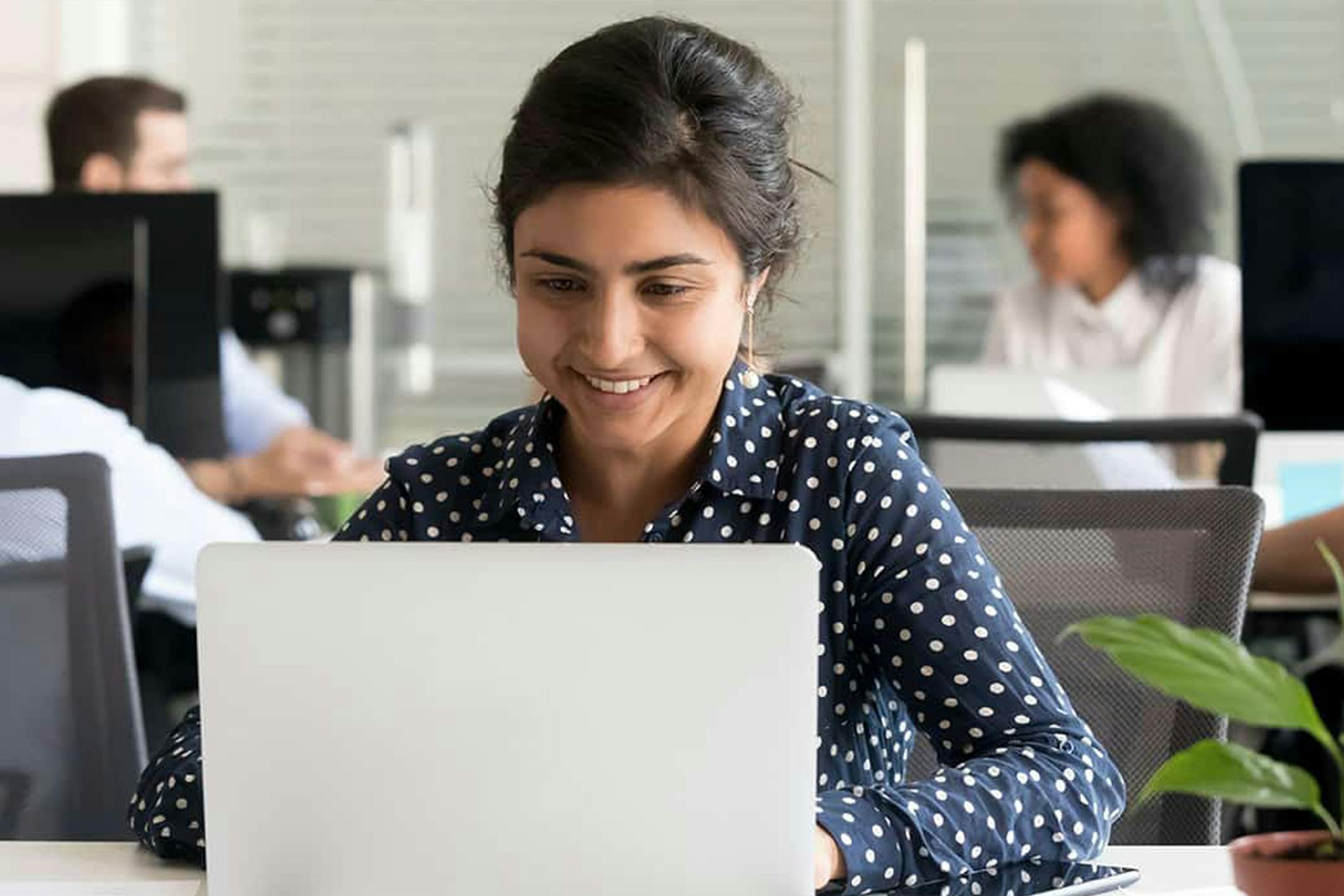 Woman working on laptop in a office