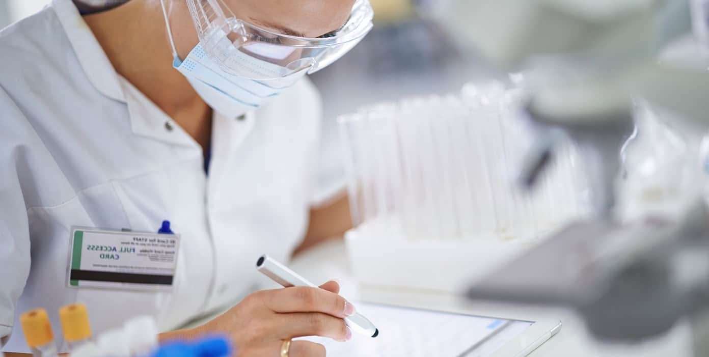 Lab technician filling out paperwork