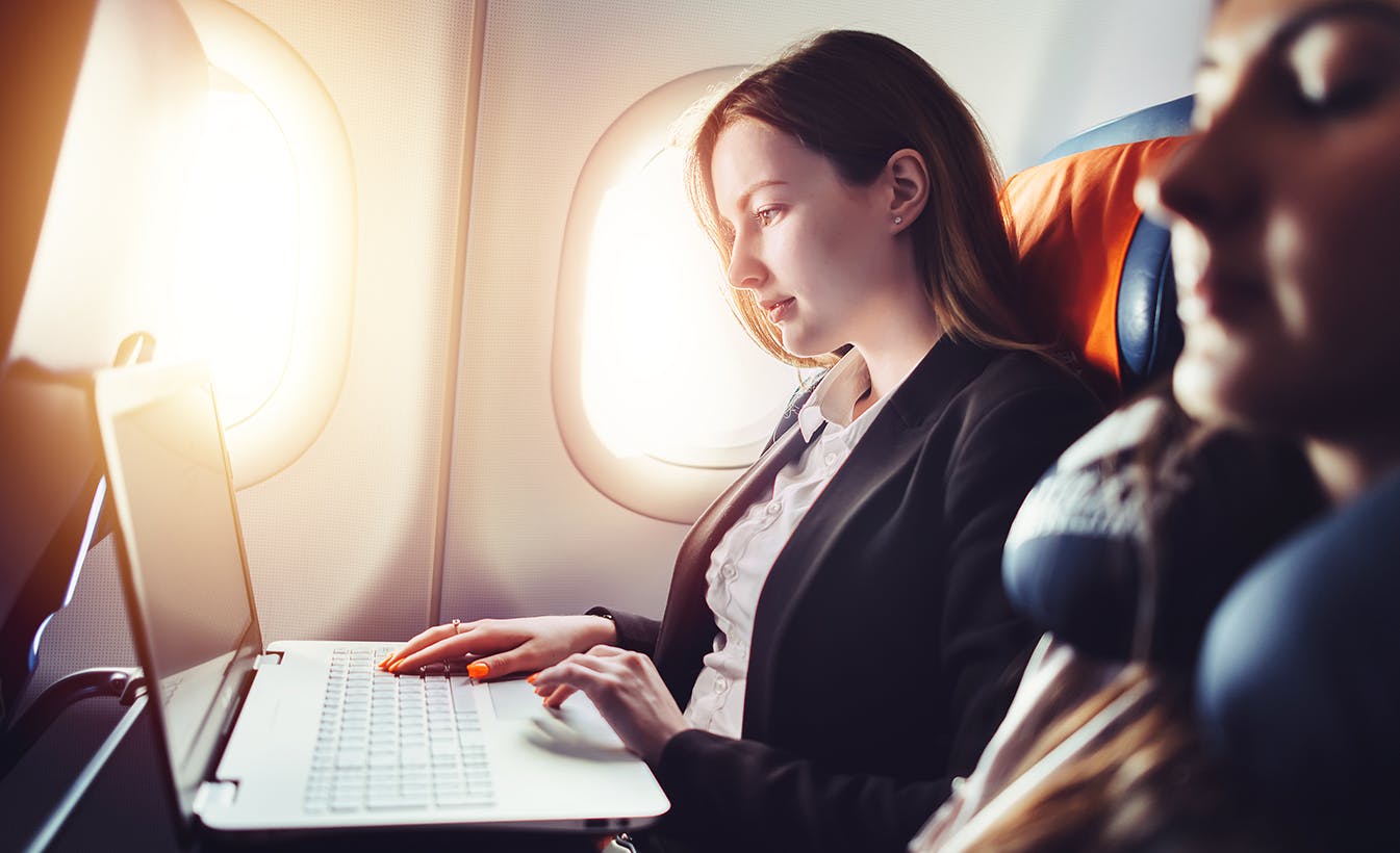 woman on airplane typing