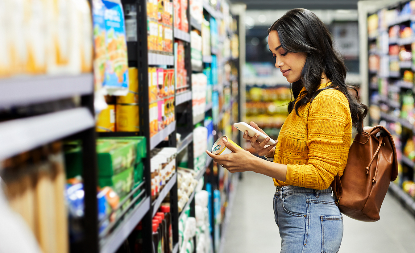 Woman in yellow shirt shopping in a grocery store