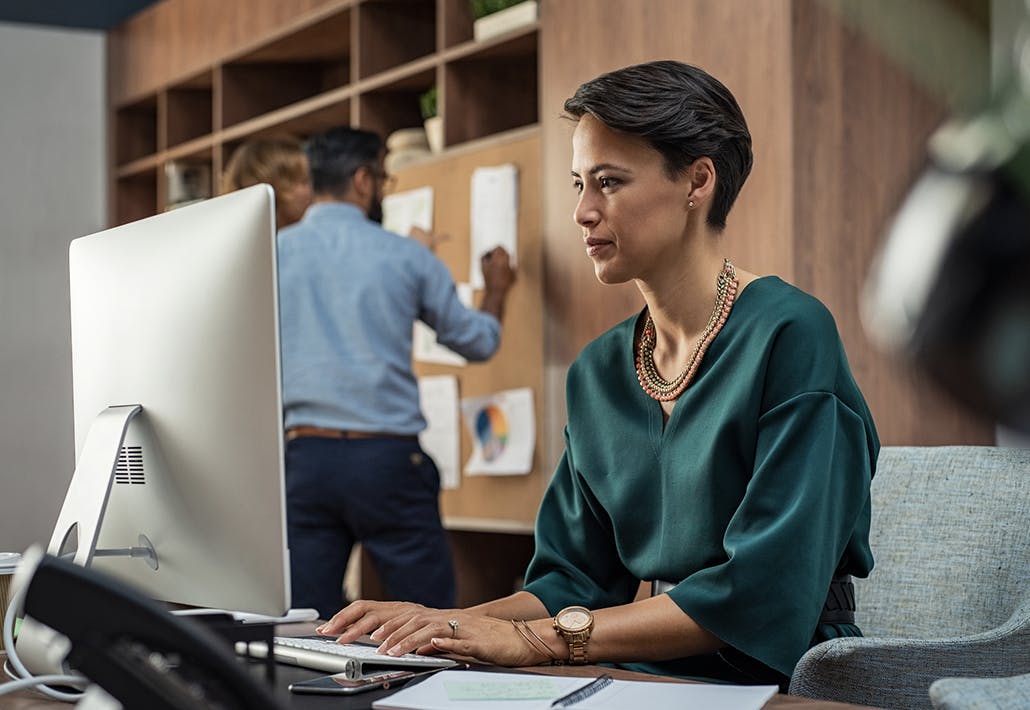 women working on a computer in an office